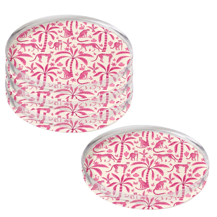 Four round acrylic coasters with leopard palms pattern on a white background